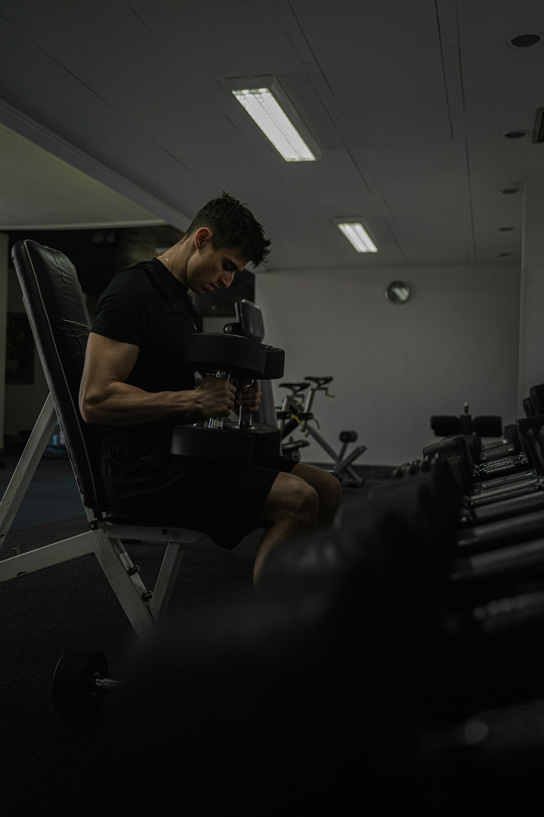 A man preparing for a weight-training exercise at the gym